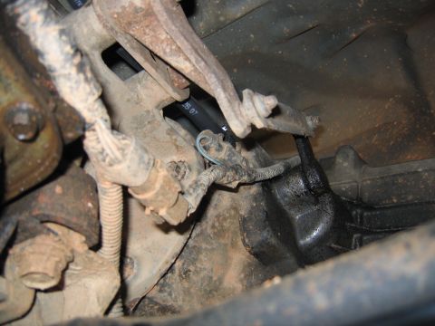 1989 Ford Bronco - transfer case vent, located inside the linkage above the electrical connector with the blue wire, faces towards front of vehicle