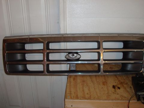 1992 Ford Bronco - A chrome and black grille, identified as likely belonging to a 1992 Ford Bronco, is shown up close.
