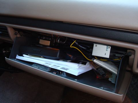 1992 Ford Bronco - Interior view of an open glove box with various items stored inside.