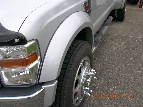 2008 Ford F-450 - Close-up of a silver dually truck's front passenger side, showing the fender, wheel, and running board.