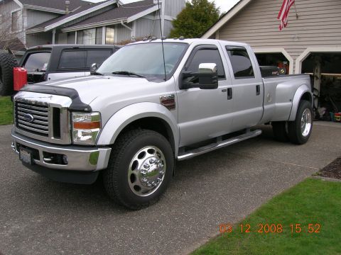 2008 Ford F-450 - Silver 2008 Ford F-450 Super Duty dually truck parked in a driveway with a house and garage in the background.