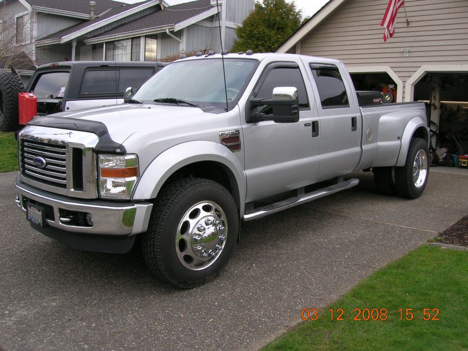 Silver 2008 Ford F-450 Super Duty dually truck parked in driveway, front 3/4 view