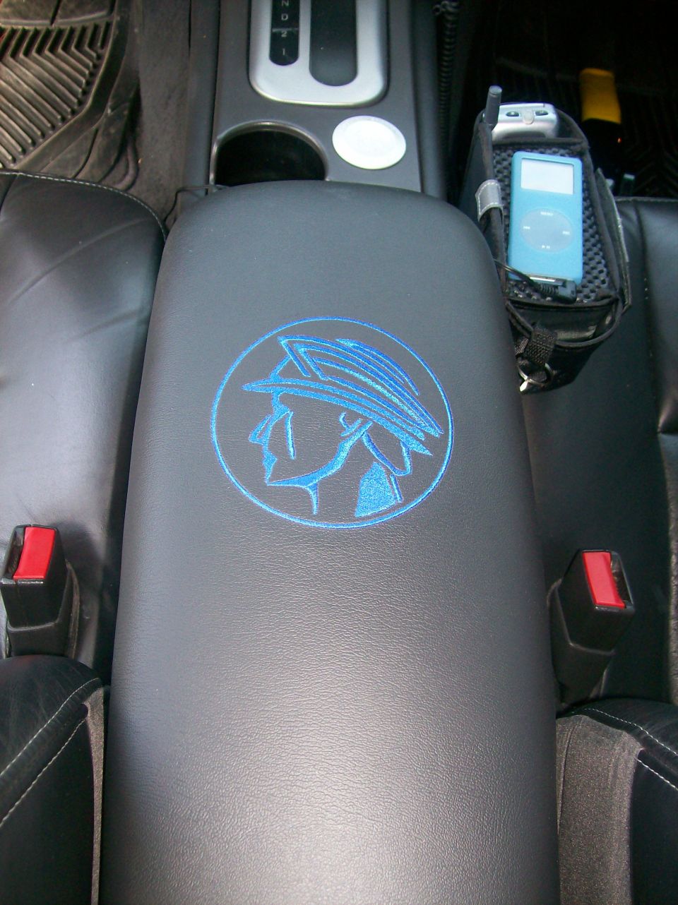 Interior center console with blue Mercury emblem and iPod holder