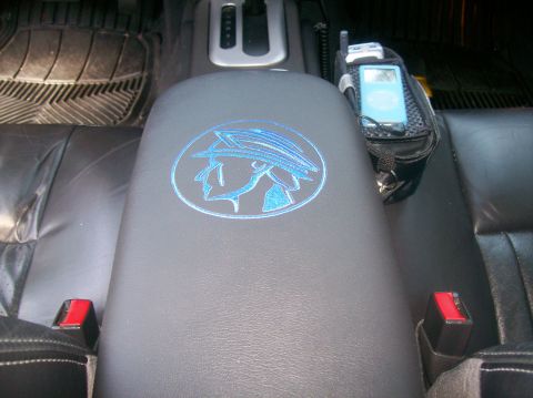 2003 Mercury Marauder - Interior shot of a car's center console a custom embroidered logo and an electronic device.