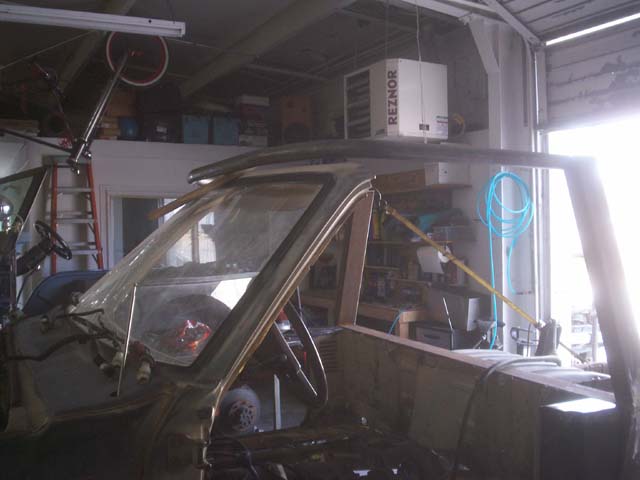 Interior of a disassembled vehicle, showing dashboard and roll cage structure