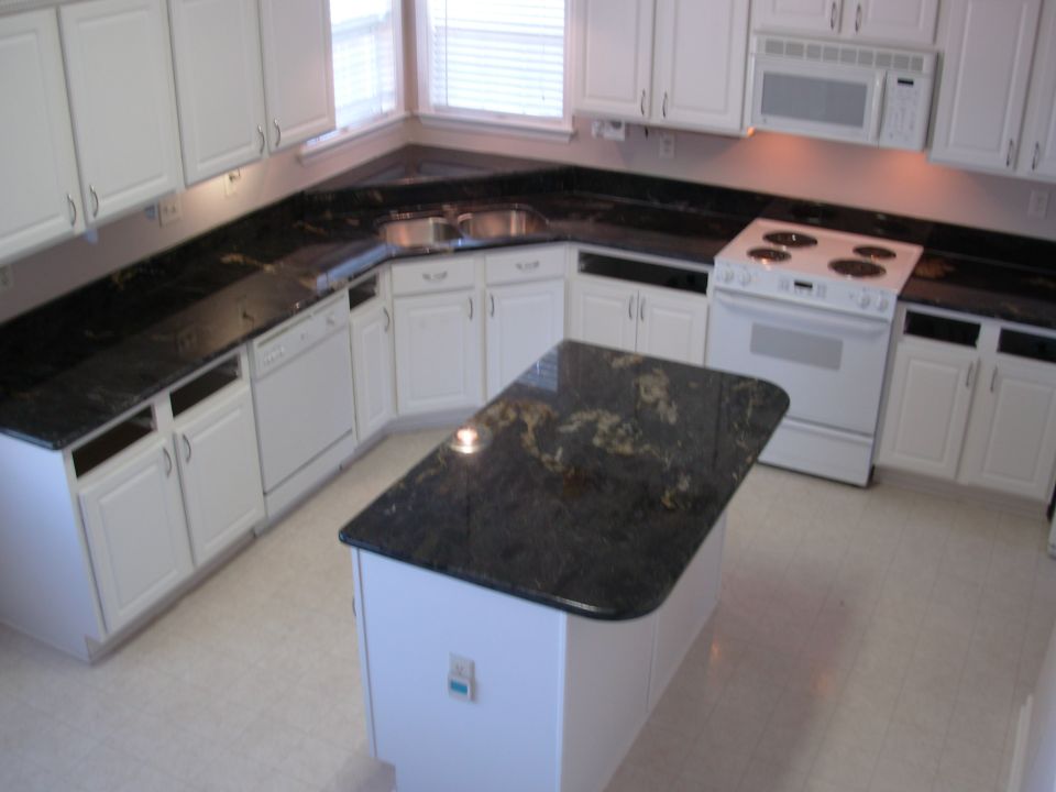 Since I had emptied the cabinets & removed the drawers before they arrived, this is how they left it.  But they didn't reconnect the plumbing, or even sweep.  The sink cabinet is full of sawdust.