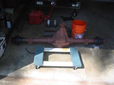 1995 Ford Bronco - A rear axle assembly is shown on a dolly in a garage setting.