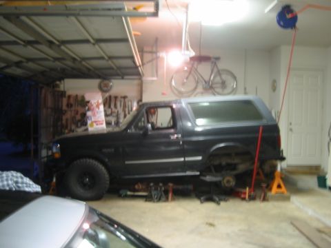1995 Ford Bronco - This 1995 Ford Bronco is undergoing maintenance in a garage, with its rear axle disassembled.