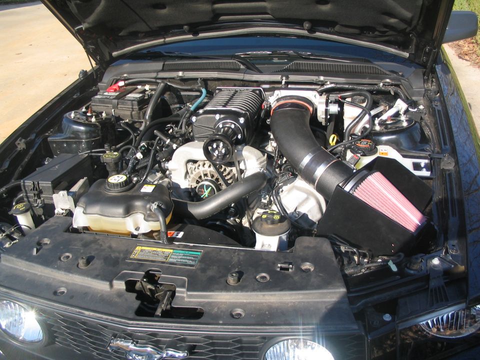 Black 2007 Ford Mustang engine with supercharger and cold air intake