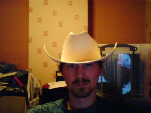 1989 Ford Bronco - Man in a cowboy hat poses for a selfie in front of a patterned wall.
