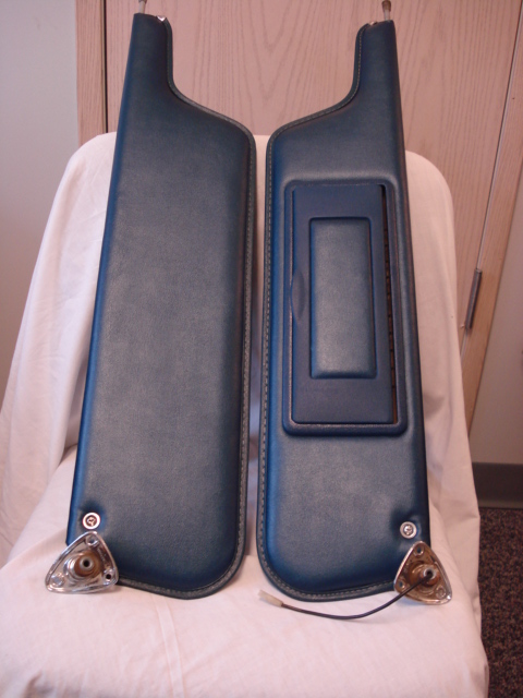 1979 Ford Bronco - A pair of blue sun visors are displayed against a white cloth and wooden background.