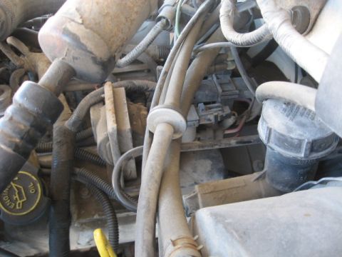 1990 Ford F-250 - A close-up view of the engine compartment, showing various hoses and wiring.