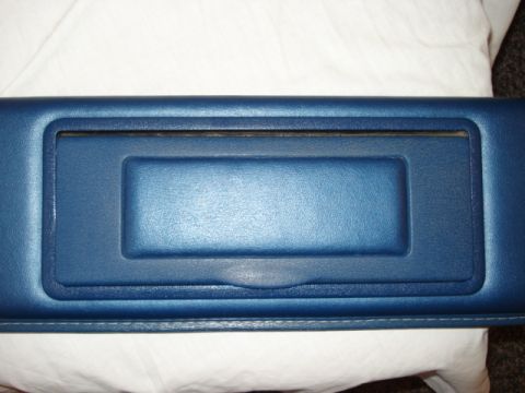 1979 Ford Bronco - A blue interior trim piece is shown, a recessed rectangular area and stitched detailing along the bottom edge.
