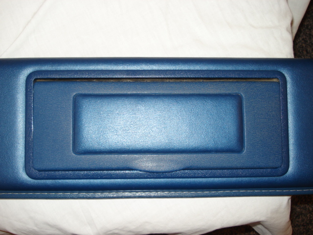 Blue interior trim piece with a rectangular cutout