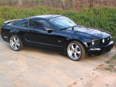2007 Ford Mustang - Black 2007 Ford Mustang GT coupe with aftermarket chrome wheels.