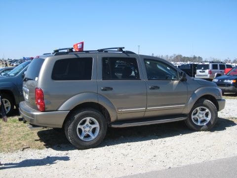 2004 Dodge Durango - Side view of a 2004 Dodge Durango SUV with a red flag on its roof rack.