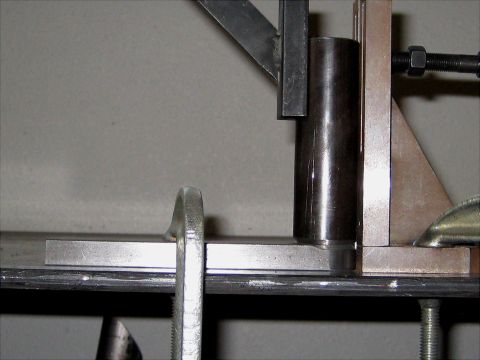 1996 Ford Bronco - A close-up view of metal fabrication equipment, including clamps and a jig, with no visible vehicle parts.
