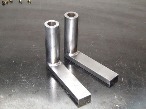1996 Ford Bronco - Custom metal brackets fabricated for a project, shown on a workbench.