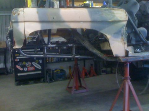 1966 Ford Bronco - Body section of a 1966 Ford Bronco undergoing work, supported by jack stands.