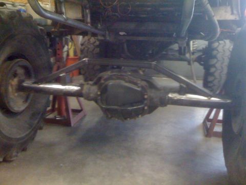 1966 Ford Bronco - Custom suspension links are attached to the rear axle assembly of a vehicle undergoing modification.