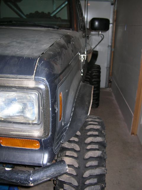 1985 Ford Bronco II - Close-up of the front fender flare and aggressive tire on a 1985 Ford Bronco II.