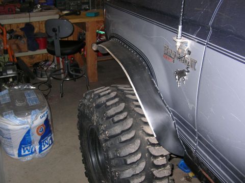 1985 Ford Bronco II - Close-up of the fender flare and tire on a Ford Bronco II, showing the vehicle's badge.