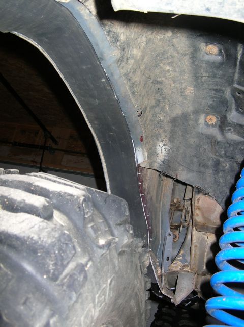 1985 Ford Bronco II - Interior view of a vehicle's wheel well, revealing the tire and suspension.