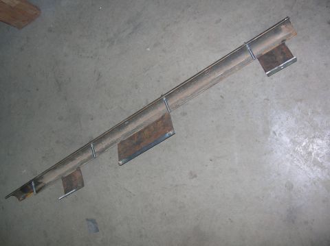 1985 Ford Bronco II - A metal rocker panel, likely for a vehicle, is shown from an overhead perspective on a concrete surface.