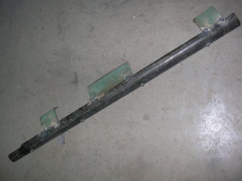 1985 Ford Bronco II - Metal pipe with welded brackets, likely a custom part or repair component.