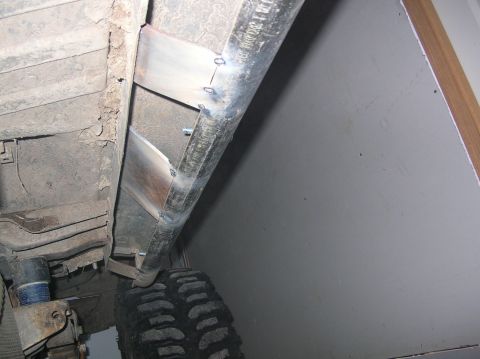 1985 Ford Bronco II - Custom metalwork is being added to the vehicle's undercarriage, reinforcing the frame.