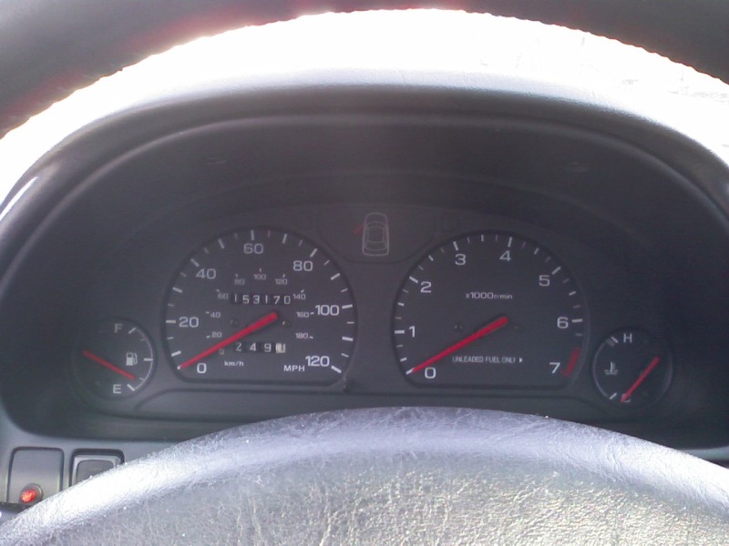 Subaru gauge cluster showing 153,170 miles, tachometer, fuel and temp gauges