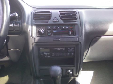 1997 Subaru Legacy - The interior of a 1997 Subaru Legacy, the center console with audio and climate controls.