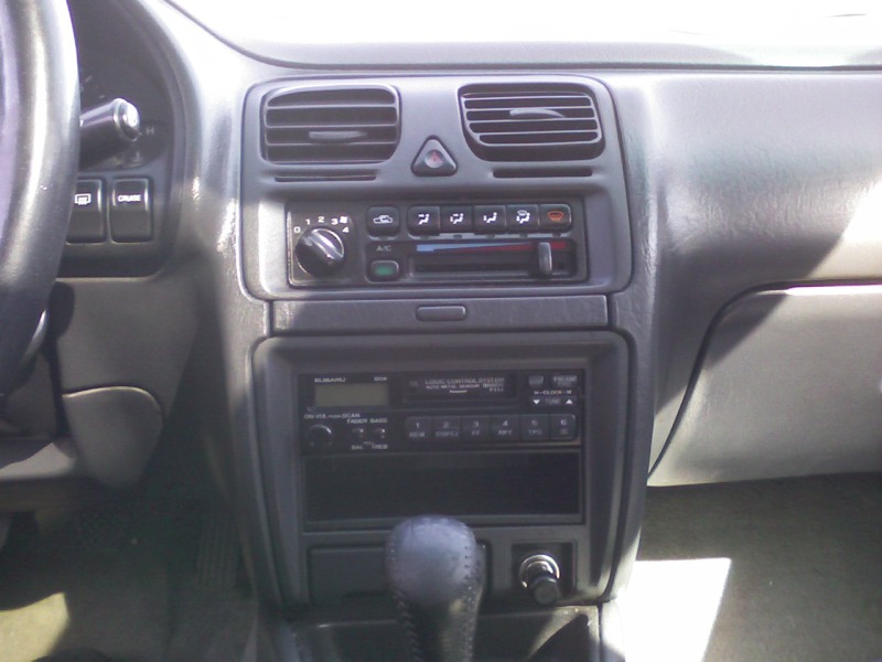 Subaru center console with HVAC sliders, factory cassette radio and shifter