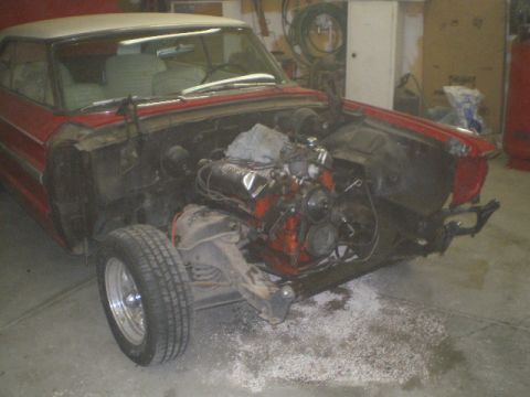 1964 Ford Galaxie - This car is in a garage with its front end disassembled and the engine removed.