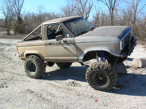 1985 Ford Bronco II - This modified 1985 Ford Bronco II features a significant lift kit and oversized off-road tires, suggesting it's built for terrain.