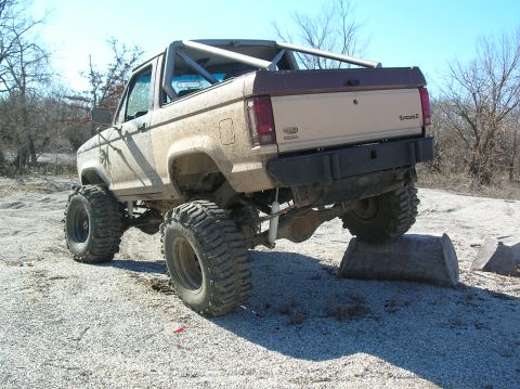 1985 Ford Bronco II - This lifted 1985 Ford Bronco II is shown off-road with its large tires and custom roll cage.