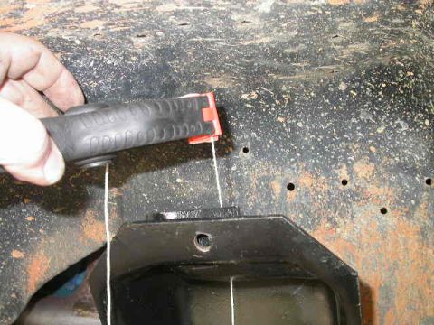 1990 Ford Bronco - Using a spring clamp to hold the plumb bob string makes it much easier to adjust the plumb bob height quickly.