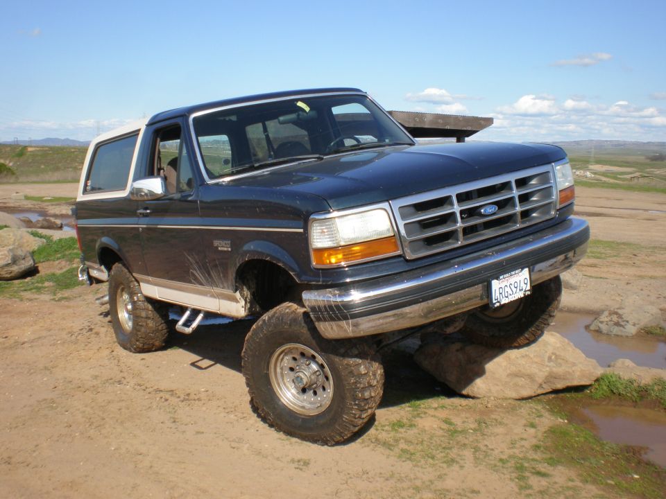 1993 Ford Bronco on rocks with front wheel elevated