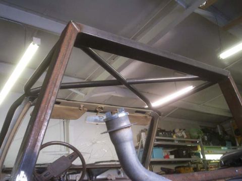 1982 Toyota 4Runner - Custom roll cage being installed in a 1982 Toyota 4Runner, showing the interior and a cracked windshield.