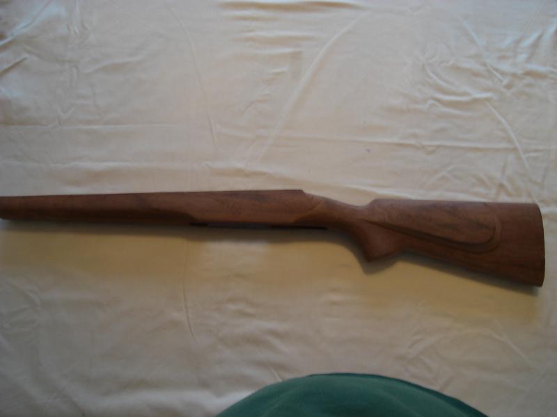 Wooden rifle stock on a white cloth background