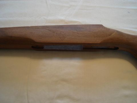 1991 Ford Bronco - A close-up view of a wooden gun stock, showing its grain and construction details.