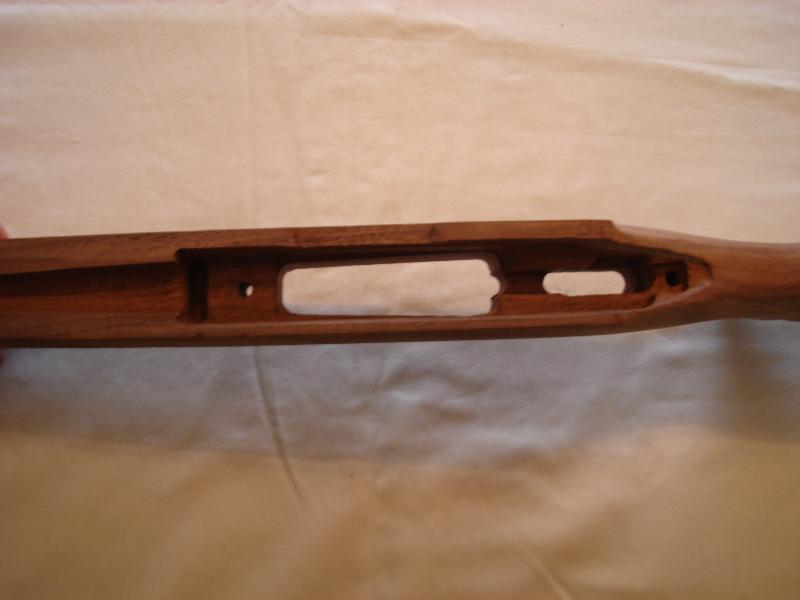 Wooden gun stock with cutouts for action and magazine