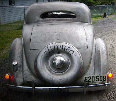 1936 Ford Coupe - Rear view of a 1936 Ford Coupe, showing the spare tire and license plate.