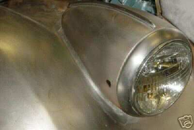 1936 Ford Coupe - The headlight and surrounding fender are visible in this close-up shot of a vehicle's front end.