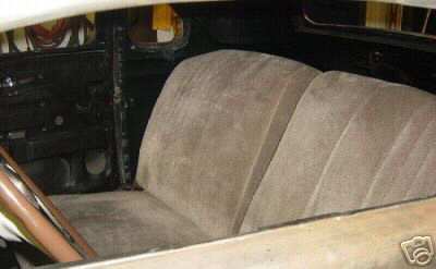 1936 Ford Coupe - The interior of a classic automobile features tan upholstered seats and a brown steering wheel, offering a glimpse into its vintage design.