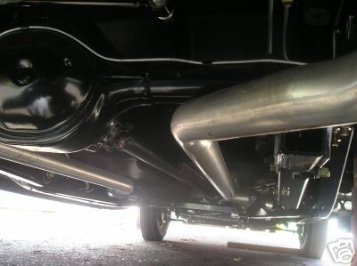 1936 Ford Coupe - A detailed view of the underside of a vehicle, focusing on the rear axle and exhaust components.