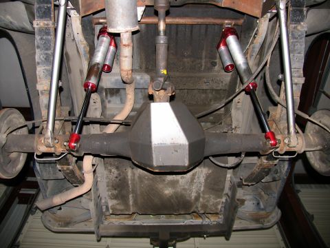 1984 Ford Bronco - Underside view shows rear axle, differential, leaf springs, and dual shock absorbers.