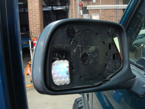 1996 Ford Bronco - Side mirror assembly with an aftermarket LED turn signal installed in place of the original mirror glass.