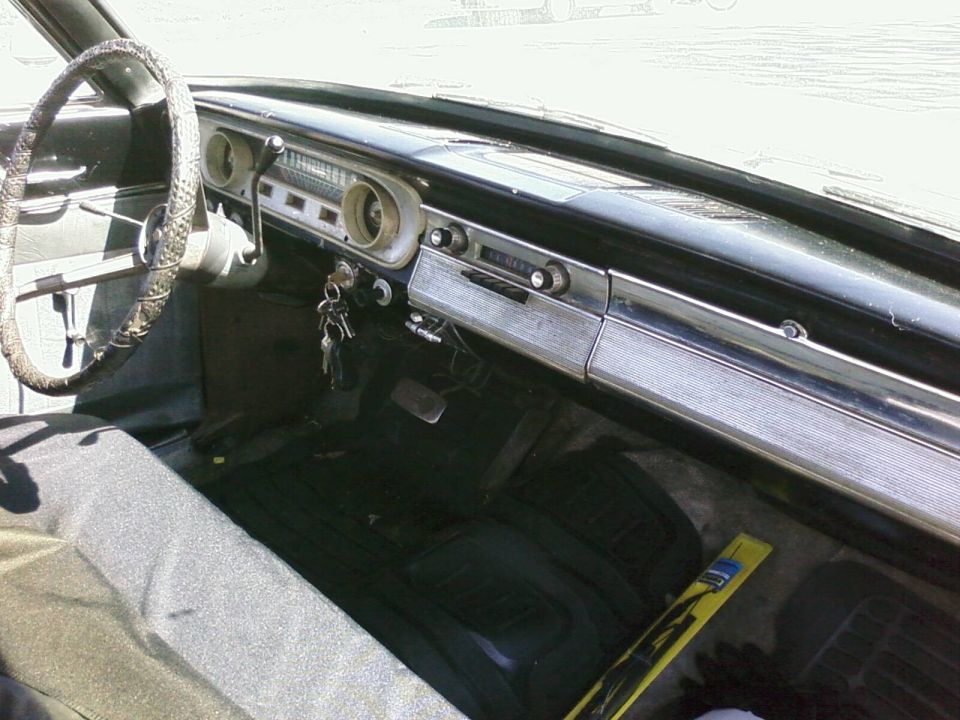 1964 Ford Ranchero interior with black dash, chrome trim, wrapped steering wheel, and keys in ignition