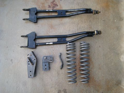 1996 Ford Bronco - Vehicle suspension components laid out on a concrete surface.